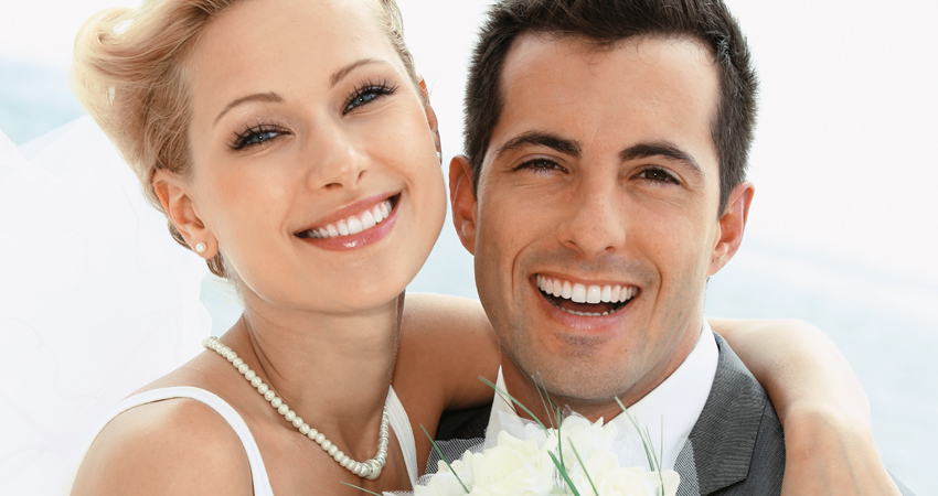 Newlyweds who have undergone dental bonding smile